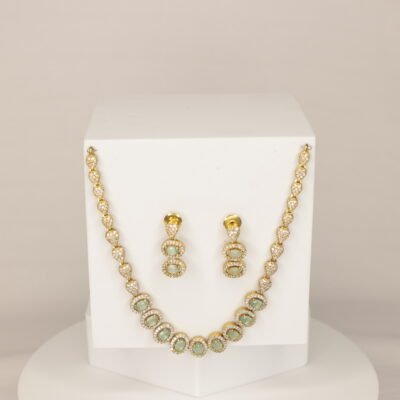 Elegant gold-plated necklace set with oval green stones and cubic zirconia sparkle