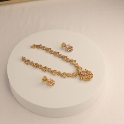 Grace meets glamour—adorn yourself with this stunning gold jewelry set featuring blush-pink elegance.